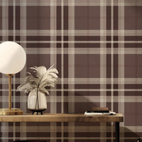 A modern dining room setup features a classic tartan plaid wallpaper in soft grey and white tones.
The textured design displays a clean grid pattern with intersecting grey lines across the wall.
In front, a dark wood dining table is paired with matching chairs with grey upholstered cushions.
The elegant room layout is beautifully completed by an open window view showing a touch of greenery.