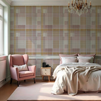 A modern bedroom features a textured plaid wallpaper in rosewood blush and warm beige tones.
The fabric-look design displays a detailed grid pattern with intersecting soft pink, cream, and tan lines.
In front, a fully dressed bed with cream linens sits next to a classic pink wingback accent chair.
The elegant, cozy space is completed by a small wooden nightstand and a soft pink area rug.