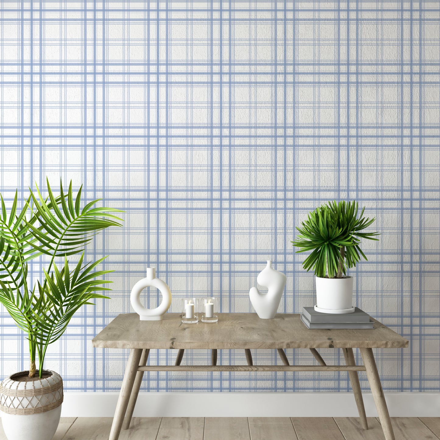 A bright interior space features a soft ivory and cornflower blue plaid wallpaper.
The detailed design shows thin blue lines intersecting to form clean grids across a white base.
In front, a rustic wooden console table holds modern ceramic vases and candles.
The breezy, minimalist setup is accented with vibrant green potted plants on both sides.