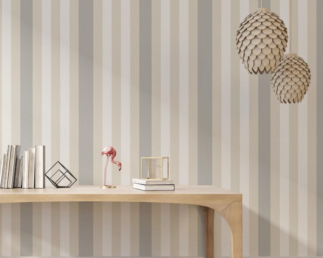 A modern living room features a textured striped wallpaper in a subtle sandstone theme.
The fabric-textured design shows clean vertical lines in light grey, cream, and warm beige.
In front, a minimalist light wooden console table sits straight in the center of the space.
The bright, open interior layout is beautifully completed by a green potted plant on the left.