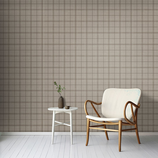 A minimal living room features a textured plaid wallpaper in desert dune tones.
The fabric-look pattern displays a structured grid with intersecting warm beige and soft tan lines.
In front, a comfortable light grey fabric sofa with a beige accent pillow is positioned on the right.
The clean interior setup is nicely completed by a dark grey wooden storage cabinet on the left.
