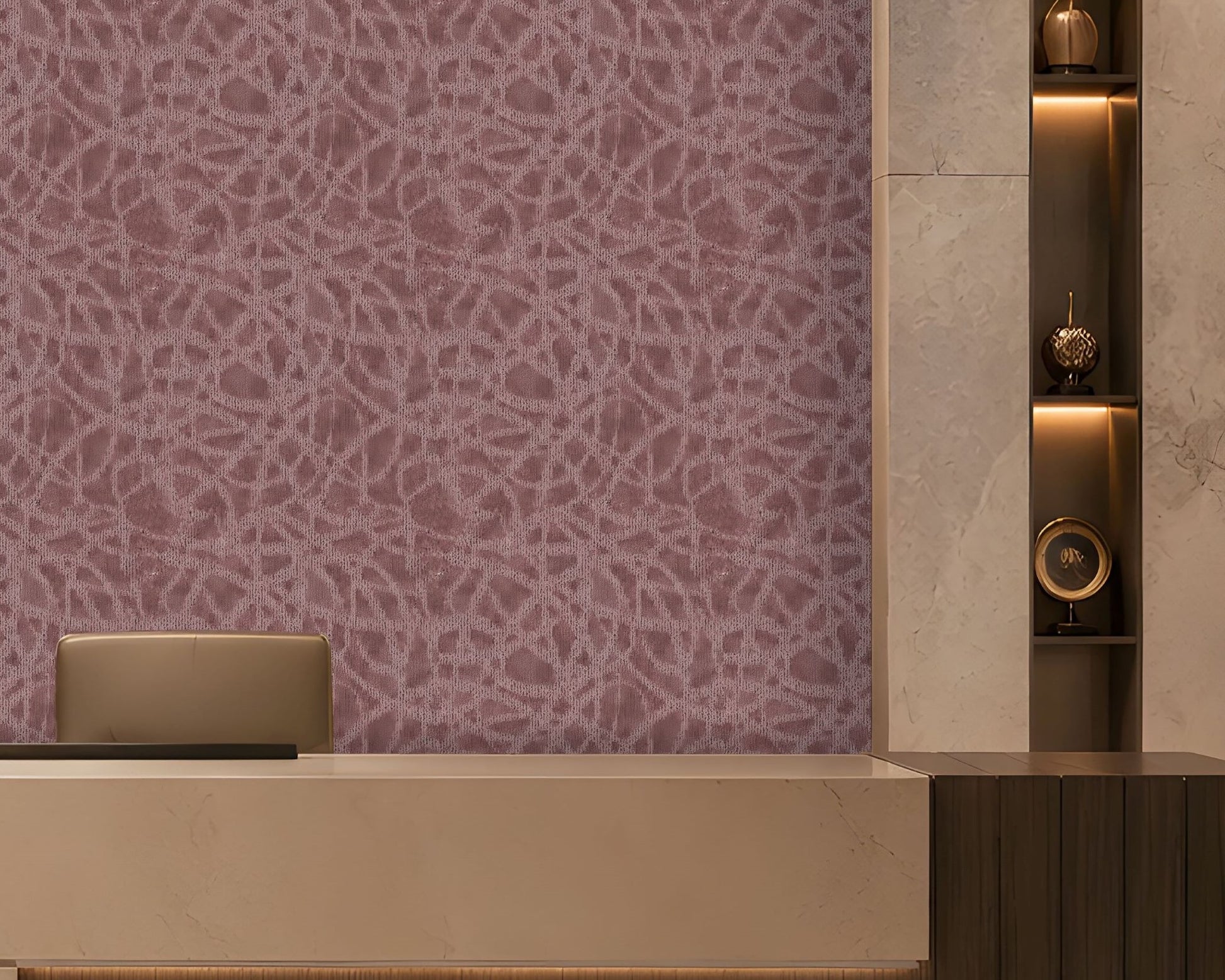 A refined contemporary reception area featuring a large curved-front desk in warm ivory stone and dark wood, with subtle integrated underlighting. The backdrop is a mauve-taupe textured feature wall with an intricate organic pattern and softly illuminated upper edge. Vertical dark-wood slats frame the left side, while marble-clad columns and illuminated display niches with sculptural décor frame the right. Warm architectural lighting, polished stone flooring, and restrained neutral tones create an elegant