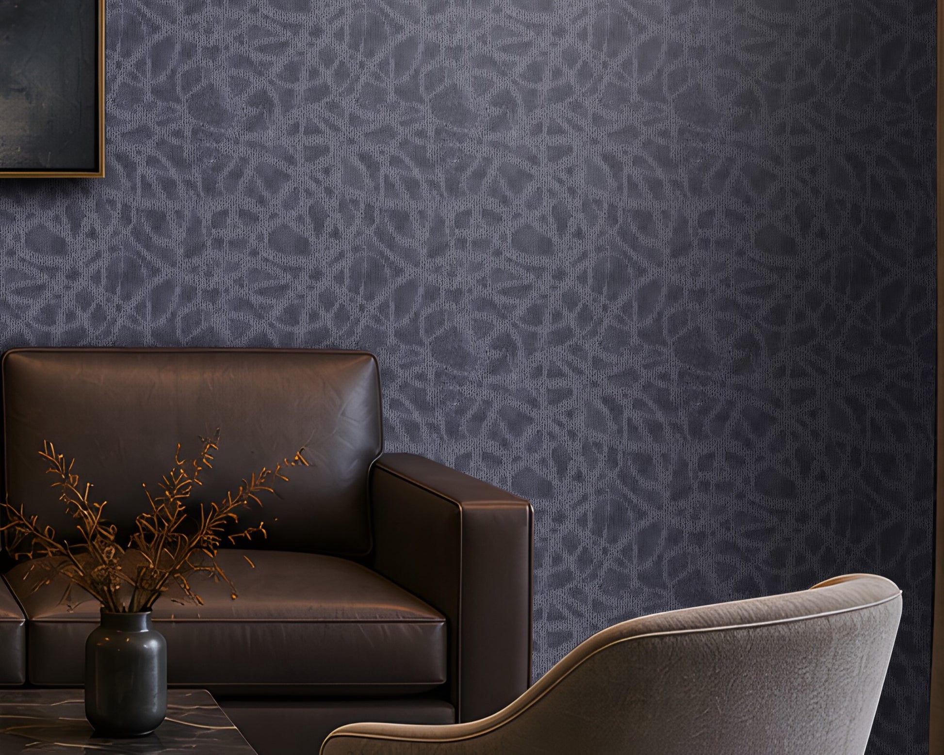 "Modern living room featuring a premium slate blue seamless texture wallpaper with an elegant organic abstract pattern that adds depth and visual interest to the walls. The sophisticated interior includes a dark brown leather sofa, two upholstered accent chairs, a black marble coffee table, warm brass table lamp, built-in wooden shelving with ambient lighting, abstract wall art, and floor-to-ceiling curtains. This luxurious textured wallpaper is ideal for contemporary