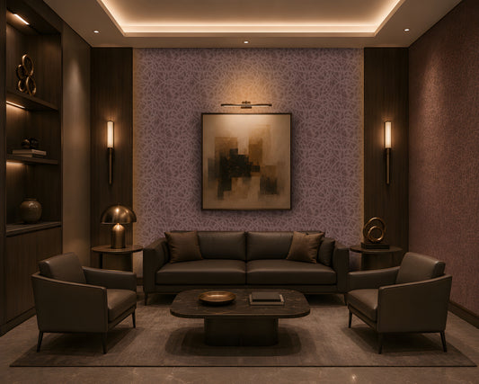 A luxurious contemporary lounge with a symmetrical layout, featuring a dark leather sofa and two matching armchairs around a low rounded rectangular marble coffee table. The room has a warm brown and taupe palette, dark wood built-in shelving, patterned textured wallpaper, brass-accented lighting, sculptural décor, and a large abstract artwork centered on the feature wall. Concealed cove lighting and warm wall sconces create an intimate, sophisticated atmosphere.

