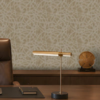A sophisticated executive office with a symmetrical, formal composition. A large walnut desk faces two brown leather guest chairs, with a high-back executive chair behind it. The room features a pale beige textured feature wall with an organic abstract pattern, dark walnut built-in cabinetry and shelving, warm integrated LED lighting, minimalist abstract artwork, sculptural décor, and a bronze desk lamp. A ribbed translucent glass partition on the right adds architectural separation while allowing filtered 