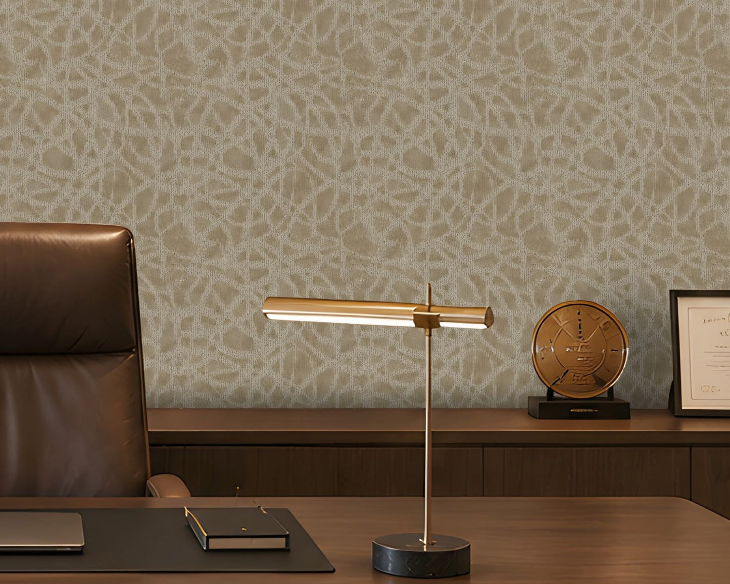A sophisticated executive office with a symmetrical, formal composition. A large walnut desk faces two brown leather guest chairs, with a high-back executive chair behind it. The room features a pale beige textured feature wall with an organic abstract pattern, dark walnut built-in cabinetry and shelving, warm integrated LED lighting, minimalist abstract artwork, sculptural décor, and a bronze desk lamp. A ribbed translucent glass partition on the right adds architectural separation while allowing filtered 
