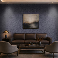 Luxury living room featuring a dark navy-blue textured wallpaper accent wall, brown leather sofa, beige lounge chairs, marble-top coffee table, warm ambient lighting, built-in shelving, and floor-to-ceiling curtains.

