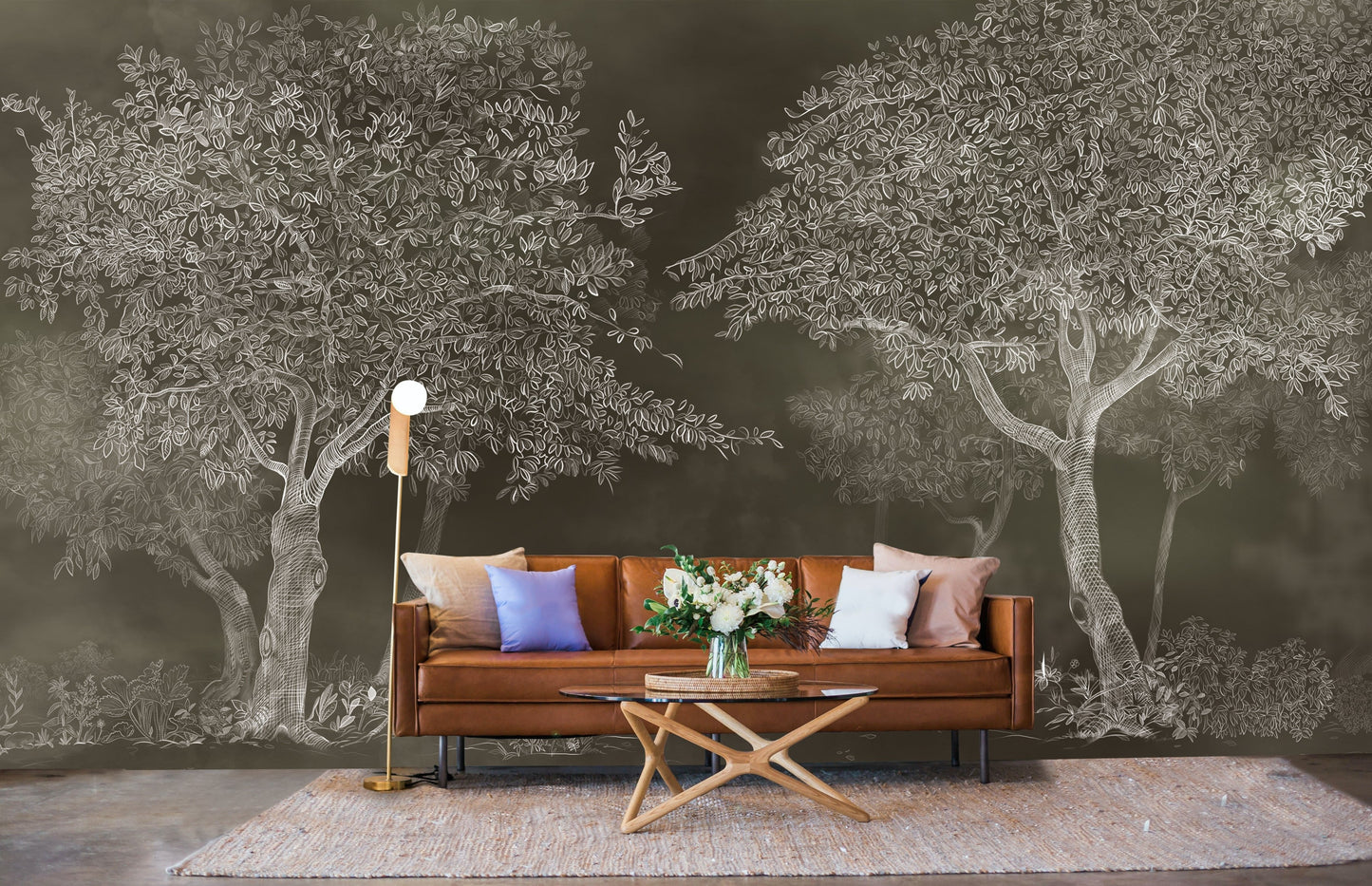 An architectural perspective of a sophisticated study featuring the Aranyam Dark Umber Mural as a full-scale feature wall behind a tan leather sofa. The mural’s dark, illustrative vista pairs elegantly with warm wooden furniture and gold accents, creating a moody and cultured interior sanctuary.