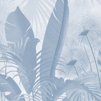 An architectural perspective of a contemporary living room featuring the Banana Grove Mural in Pacific Blue as a full-scale feature wall behind a low-profile cream sofa. The mural’s cooling botanical composition pairs elegantly with light oak flooring and neutral textiles, creating a peaceful and immersive coastal-inspired retreat.