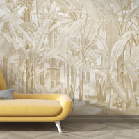 A high-resolution detail of the Banana Grove Dreams Beige Wallpaper, highlighting the delicate, hand-painted veining of the large leaves and the intricate textures of the tropical blossoms. The image showcases the refined tonal transitions between warm beige, soft sand, and muted ivory that define this elegant botanical mural.