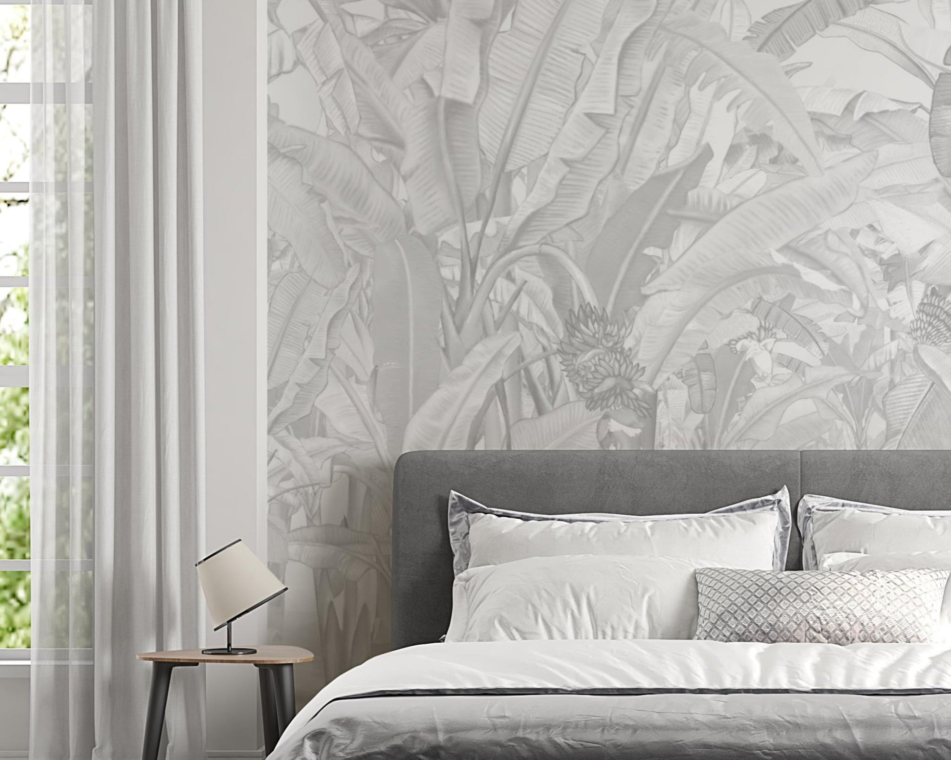 A high-resolution detail of the Banana Grove Dreams Grey Wallpaper, highlighting the delicate painterly textures and hand-painted veining of the tropical leaves. The image showcases the refined tonal transitions between smoky charcoal, misty grey, and soft ivory that define this nature-inspired mural.