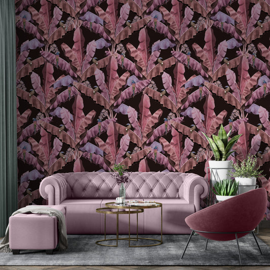 An architectural perspective of a contemporary lounge featuring the Banana Leaves Pattern as a full-scale feature wall. The wallpaper’s deep maroon and wine tones pair strikingly with cognac leather seating, brass lighting, and minimalist decor, creating a sophisticated and high-energy tropical atmosphere.