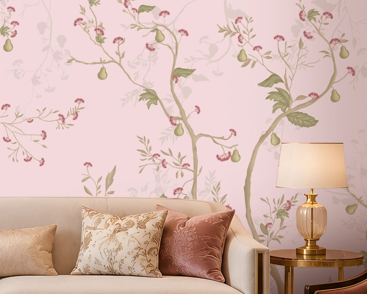 Blush Pink floral wallpaper featuring an elegant botanical design with delicate soft pink blossoms, muted green leaves, graceful winding branches, and subtle ivory floral detailing, creating a sophisticated and seamless visual flow across the feature wall. The wallpaper is showcased in a luxurious contemporary living room with a soft neutral sofa, blush pink velvet accent chairs, decorative cushions, gold-finished side tables, elegant table lamps, a statement crystal chandelier.