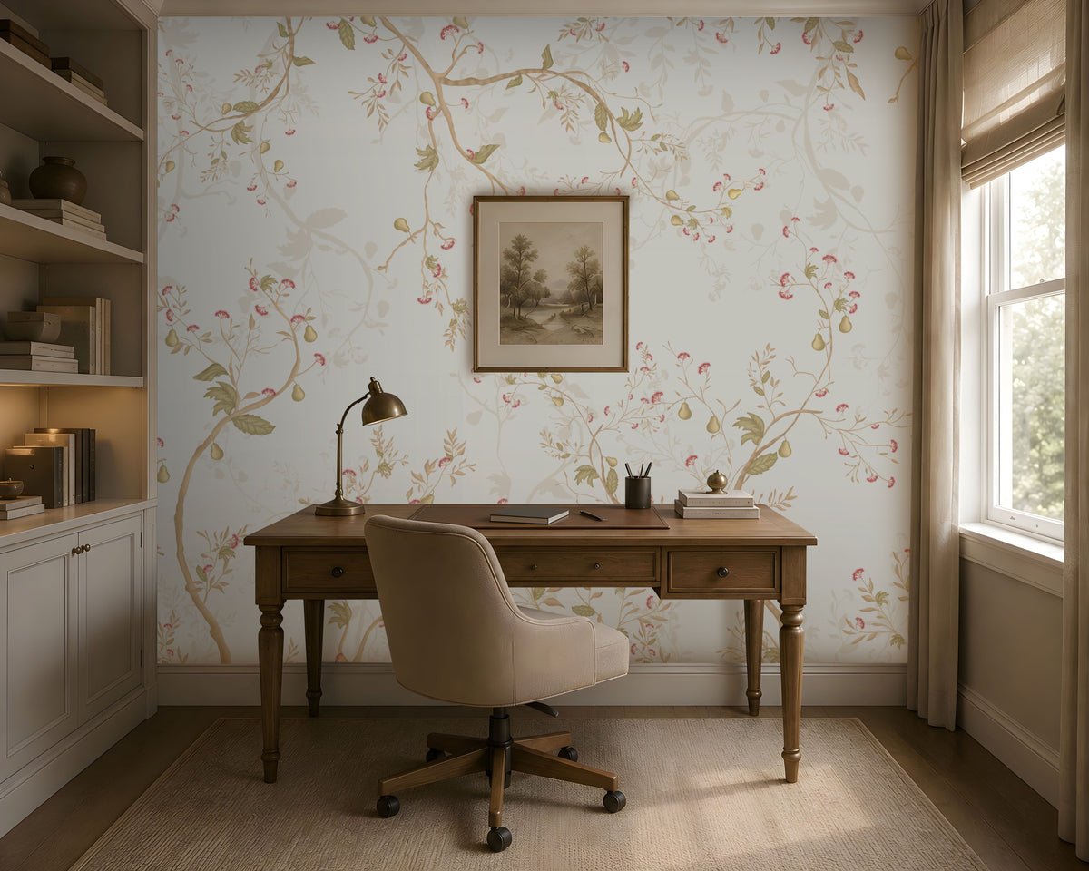 "A cozy home office with a wooden desk, beige swivel chair, brass desk lamp, and books neatly arranged. A framed landscape artwork hangs above the desk against light floral wallpaper. Built-in shelves with books and decor sit to the left, while a window on the right brings in natural light. A neutral rug covers the floor, complementing the warm and elegant aesthetic."  