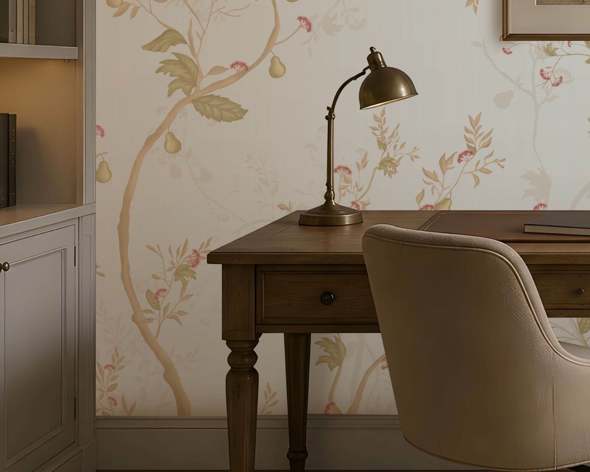 "A cozy home office with a wooden desk, beige swivel chair, brass desk lamp, and books neatly arranged. A framed landscape artwork hangs above the desk against light floral wallpaper. Built-in shelves with books and decor sit to the left, while a window on the right brings in natural light. A neutral rug covers the floor, complementing the warm and elegant aesthetic."  