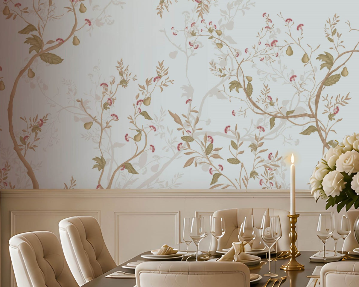 An elegant dining room featuring a long wooden table set with fine dinnerware, gold candlesticks, and a white rose centerpiece. Ten upholstered beige chairs surround the table. The walls are covered in light blue floral wallpaper, with a dark wooden sideboard and lamps on the right beneath a large mirror. Natural light filters through tall windows with beige curtains, illuminating the patterned rug and refined, classic décor.  