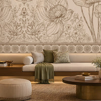 A large-scale floral wall mural with detailed poppy and wildflower line art in beige and brown tones, displayed in a modern living room setting above a long white sofa with green cushions.