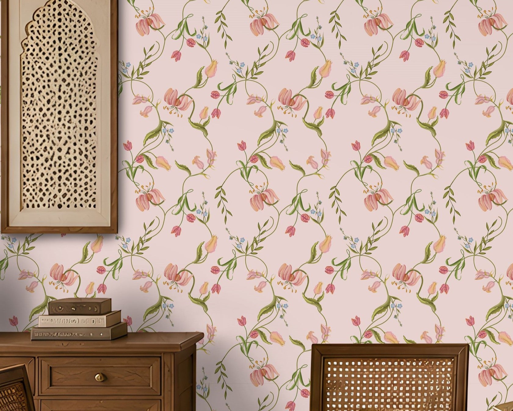 A dining room interior featuring a light pink floral wallpaper as the main wall backdrop, with a wooden dining table and woven-back chairs placed in front of it. A hanging lantern, sideboard, and decorative wall art are also visible. 