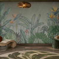 Earthy Tropical Oasis - Misty Sage Grey botanical wallpaper featuring lush tropical foliage, oversized bird-of-paradise flowers in soft orange, coral, and muted blue tones, and layered olive green leaves against a soothing misty sage grey background. This elegant botanical design brings together subtle grey-green undertones and vibrant tropical elements, creating a balanced, nature-inspired aesthetic. Perfect for enhancing living rooms, bedrooms, dining areas, and stylish contemporary interiors