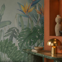 Earthy Tropical Oasis - Misty Sage Grey botanical wallpaper featuring lush tropical foliage, oversized bird-of-paradise flowers in soft orange, coral, and muted blue tones, and layered olive green leaves against a soothing misty sage grey background. This elegant botanical design brings together subtle grey-green undertones and vibrant tropical elements, creating a balanced, nature-inspired aesthetic. Perfect for enhancing living rooms, bedrooms, dining areas, and stylish contemporary interiors