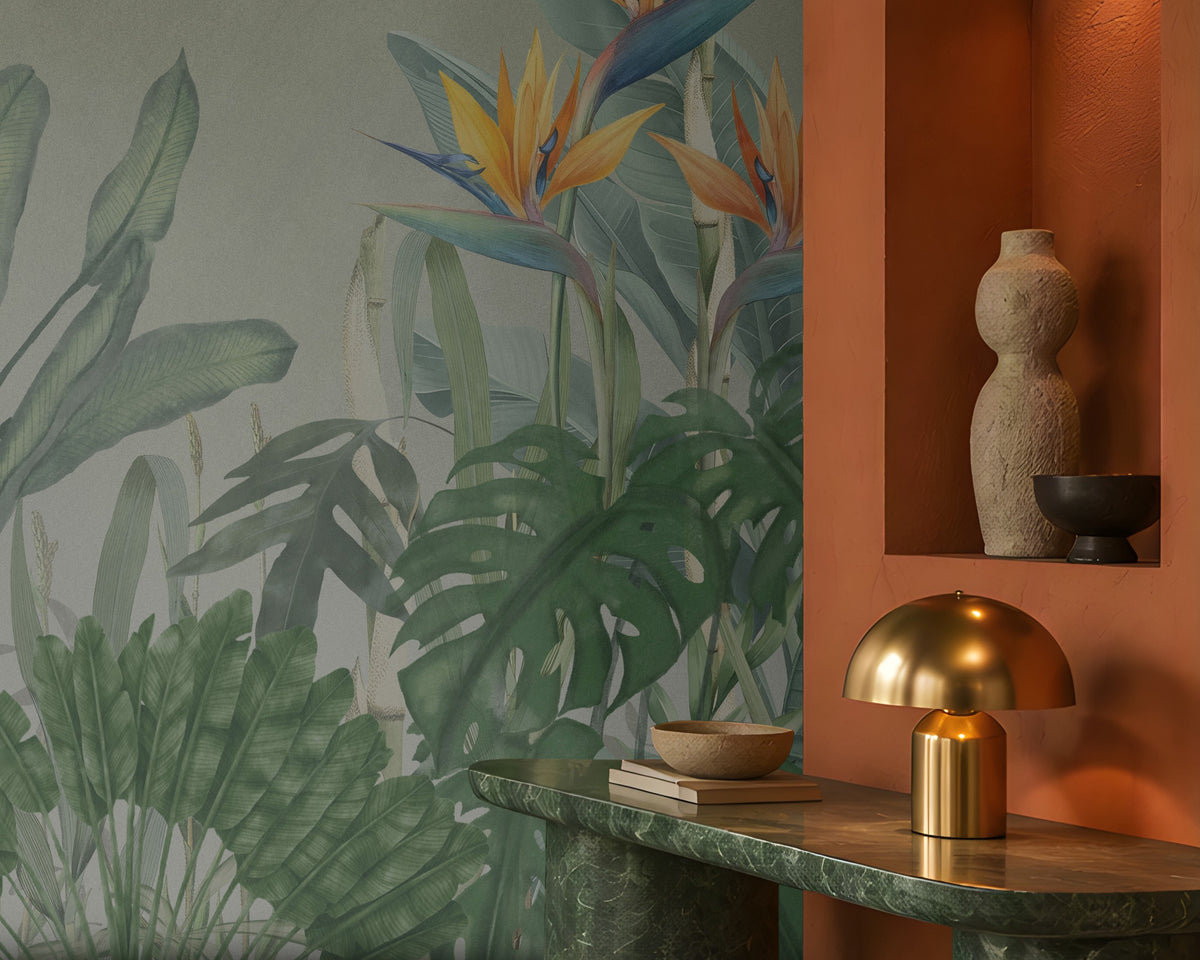 Earthy Tropical Oasis - Misty Sage Grey botanical wallpaper featuring lush tropical foliage, oversized bird-of-paradise flowers in soft orange, coral, and muted blue tones, and layered olive green leaves against a soothing misty sage grey background. This elegant botanical design brings together subtle grey-green undertones and vibrant tropical elements, creating a balanced, nature-inspired aesthetic. Perfect for enhancing living rooms, bedrooms, dining areas, and stylish contemporary interiors