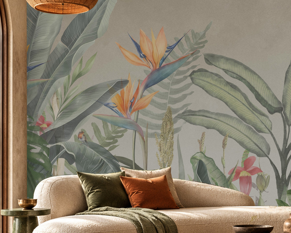 Earthy Tropical Oasis - Olive Green botanical wallpaper featuring lush tropical leaves, oversized bird-of-paradise flowers in golden yellow, orange, and muted blue, and delicate pink floral accents against a warm beige background. Displayed in a spacious, elegant living room with a curved cream sofa, natural wood furniture, woven textures, and earthy decorative elements, this nature-inspired wallpaper creates a serene tropical atmosphere with sophisticated olive green tones.