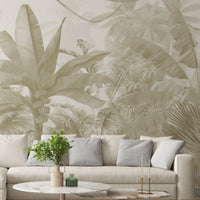 A high-resolution detail of the Enchanted Tropics Tropical Wallpaper, showcasing the intricate, illustrative linework of the banana fruit clusters and the fine textures of the towering palm fronds. The image highlights the gentle tonal transitions between sand beige, muted taupe, and soft slate grey that define this exotic jungle mural.