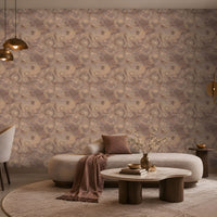 A spacious modern living room featuring a large accent wall adorned with seamless floral swirl wallpaper in warm taupe, muted dusty mauve, and soft beige tones. The intricate repeating pattern creates an elegant textured effect, beautifully complementing the neutral curved sofa, plush cream rug, marble coffee table, and warm wooden accents. Soft ambient lighting, brass pendant lights, and subtle mauve cushions enhance the sophisticated, earthy aesthetic, showcasing the wallpaper as the focal point 