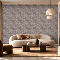 Ethereal Waves Wallpaper in Taupe Grey featuring an intricate flowing wave pattern with soft taupe, warm grey, and subtle beige tones, displayed in a luxurious modern living room with an elegant curved sofa, wooden furniture, warm pendant lighting, and neutral décor.