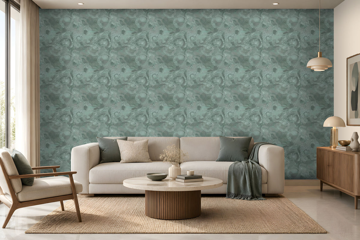 Modern minimalist living room featuring a calming teal and natural wood color palette. A large statement wall covered in textured teal wallpaper with an intricate swirling pattern forms the backdrop to the space. Positioned in front of the wall is a cream-colored sofa accented with soft green and ivory cushions, with a matching teal throw blanket draped over the right armrest.