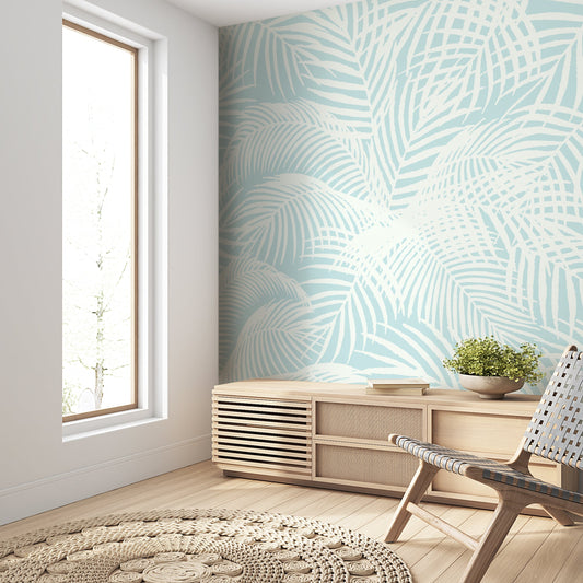 An architectural perspective of a sun-drenched reading nook featuring the Exotic Foliage Mural as a full-scale feature wall. The mural’s cool, airy tones pair elegantly with light oak furniture, a woven jute rug, and minimalist décor, creating a peaceful and cultured interior sanctuary.