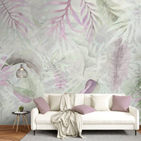 Silver pink colour Exotica Blend tropical leaf mural wallpaper installed as a feature wall in a living room, dining room, and bedroom, showcasing soft pink tones and modern tropical mural wallpaper design.