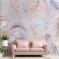 Pastel coral colour Exotica Blend tropical leaf mural wallpaper installed as a feature wall in a living room, dining room, and bedroom, showcasing soft coral tones and modern tropical mural wallpaper design.