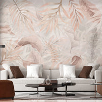 Gentle peach colour Exotica Blend tropical leaf mural wallpaper displayed as a feature wall in a living room, dining room, and bedroom, highlighting soft peach tones and modern tropical mural wallpaper design.