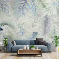 Muted gray colour Exotica Blend tropical leaf mural wallpaper displayed as a feature wall in a living room, dining room, and bedroom, highlighting neutral gray tones and modern tropical mural wallpaper design.