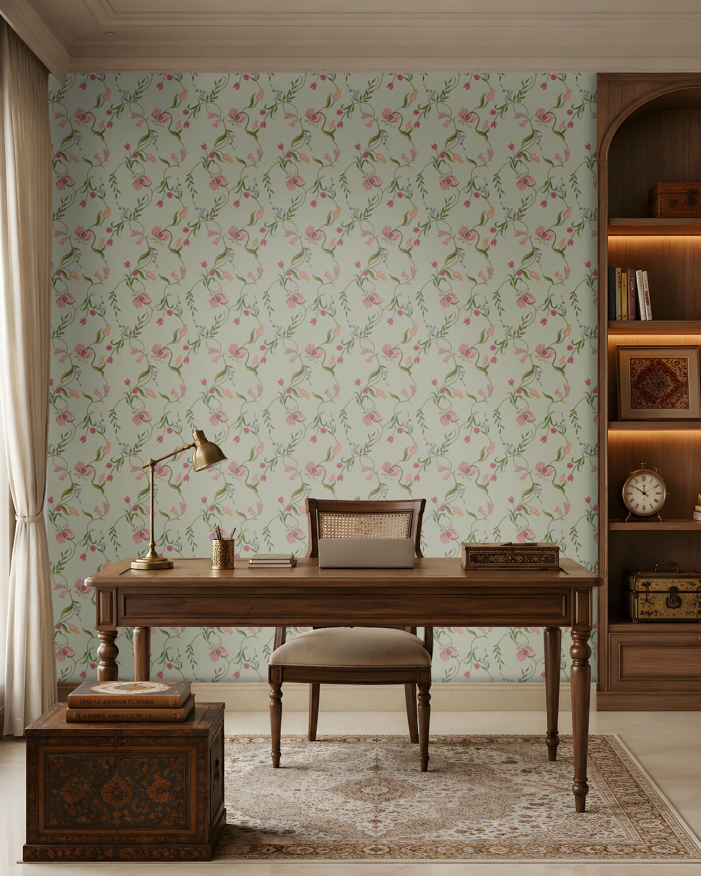 Sage green seamless floral wallpaper featuring an intricate repeating pattern of delicate pink, blush, and peach flowers intertwined with slender green botanical vines and leaves. The elegant floral motifs are arranged in a balanced continuous pattern, creating a soft, graceful, and sophisticated look. The muted pastel palette complements traditional Indian-inspired interiors while adding a fresh, serene, and luxurious character to the wall.
