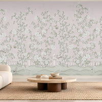 Elegant living room featuring Florentine Bloom blush pink floral wallpaper with white roses and botanical vines, complemented by a cream sofa, natural wooden furniture, and soft daylight.