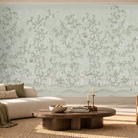 Elegant living room featuring Florentine Bloom sage green floral wallpaper with white roses and botanical vines, complemented by a cream sofa, natural wooden furniture, and soft daylight.