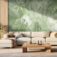 An architectural perspective of a high-end sunroom featuring the Foliage Fresco Mural in Cool Green as a full-scale feature wall. The mural’s soft, monochromatic green tones pair strikingly with light oak furniture and stone textures, creating a peaceful and cultured interior sanctuary bathed in natural light.