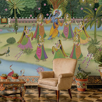 A high-resolution detail of the Krishna Pichwai Mural Wallpaper, showcasing the fine, traditional brushwork and ornamental detailing of the figures and flora. The image highlights the vibrant contrast between the saffron-clad Gopis and the rich, multi-tonal greenery of the Vrindavan landscape.