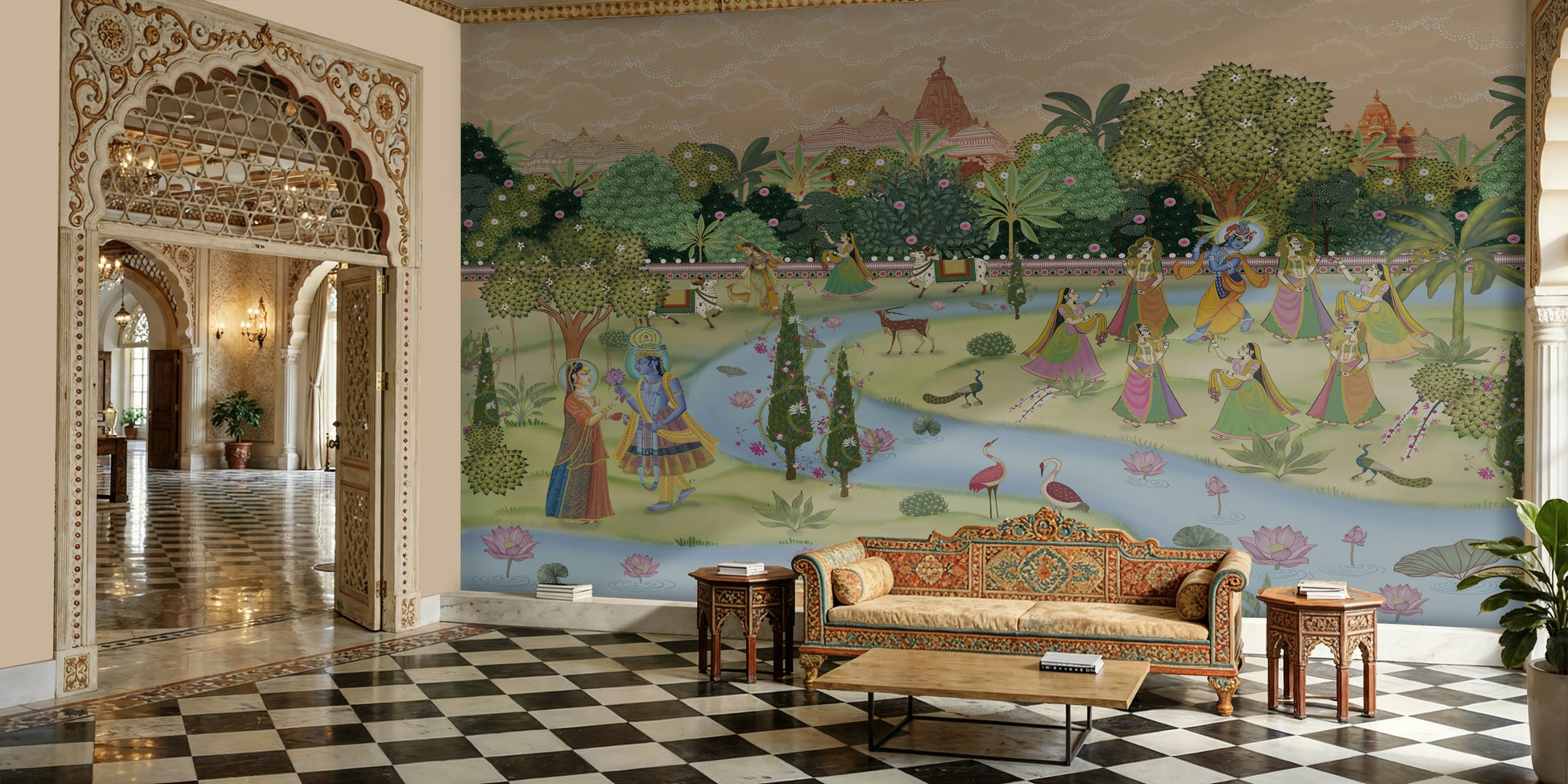 A panoramic architectural view of a luxury Indian palace interior featuring a full-scale Krishna Pichwai Mural Wallpaper. The mural depicts Lord Krishna in a sacred garden setting, paired with an ornate carved archway, checkered marble flooring, and traditional Rajasthani furniture.