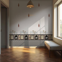 Black-and-white interior room with patterned wallpaper featuring small animal illustrations and geometric borders. A cushioned bench sits along the right wall beneath a window, while a hanging ceiling light is centered above. Sunlight streams through the window, casting distinct shadows on the wall and wooden floor, and an open doorway is visible on the left.
