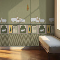 Green-toned interior wall with a repeating chevron pattern and decorative border featuring illustrated cows and plant motifs. A cushioned bench sits to the right near a window, where sunlight casts soft shadows across the wall and wooden floor.