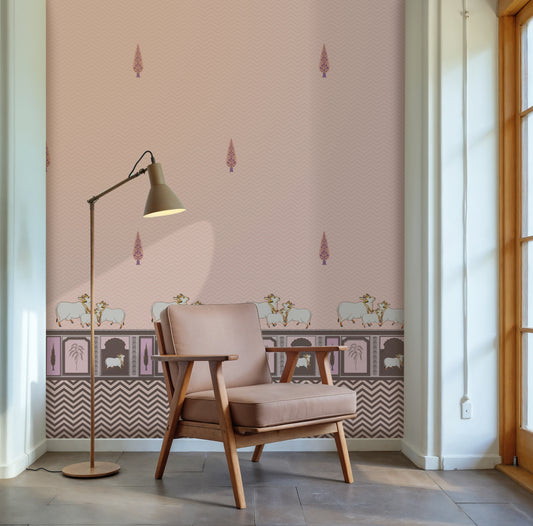 Light pink Pichwai wallpaper with cow motifs, traditional border detailing, and subtle chevron pattern for elegant Indian interiors.