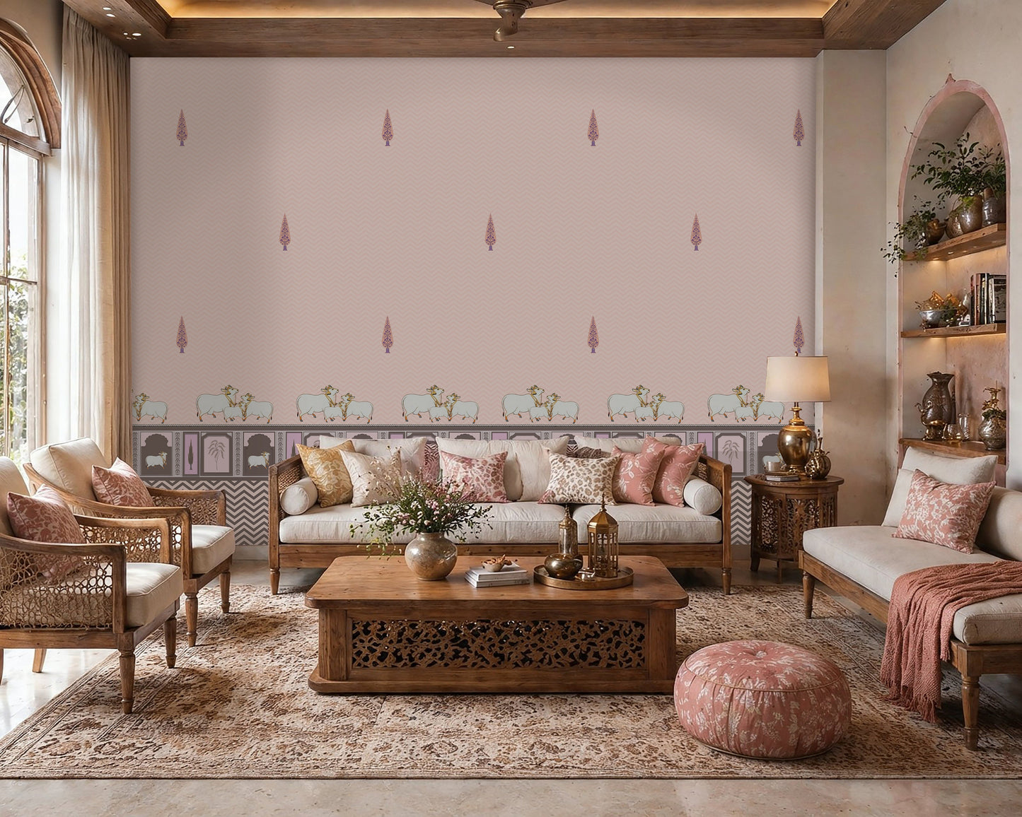 An architectural perspective of a high-ceilinged, sunlit room featuring the Heritage Pichwai Wallpaper as a sophisticated feature wall. The mural’s soft pink and pastel tones pair elegantly with traditional carved wooden furniture, neutral upholstery, and natural woven accents, creating a space that blends classical Indian heritage with a modern, airy aesthetic.