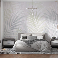 An architectural perspective of a contemporary sunlit lounge featuring the Hush Leaves Mural in Pale Green as a full-scale feature wall. The mural’s soft verdant tones pair elegantly with light birch furniture, white linen upholstery, and natural woven accents, creating a serene and sophisticated interior sanctuary.