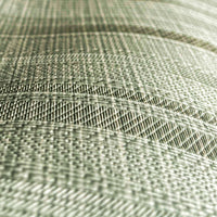 A high-resolution macro detail of Sage Waterproof Wallcovering, showcasing a unique hybrid herringbone and basket-weave emboss. The image captures rhythmic, arched bands of dense textile texture, revealing a high-tactile, light-diffusing surface designed for industrial-grade durability.