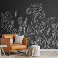 An architectural perspective of a modern living room featuring the Linear Tropical Forest Mural as a full-scale feature wall. The mural’s dark gray and white tones pair strikingly with a cognac leather armchair, light wood flooring, and minimalist furniture, creating a sophisticated and high-impact interior atmosphere.