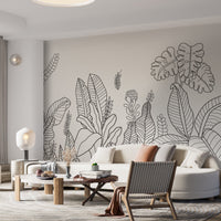 An architectural perspective of a modern living room featuring the Linear Tropical Forest Mural as a full-scale feature wall. The mural’s dark gray and white tones pair strikingly with a cognac leather armchair, light wood flooring, and minimalist furniture, creating a sophisticated and high-impact interior atmosphere.
