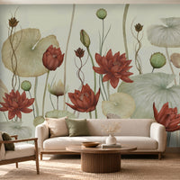 A large-scale wall mural featuring water lotus flowers and lily pads in muted earthy tones, displayed behind a cream sofa and wooden coffee table in a modern living room setting.